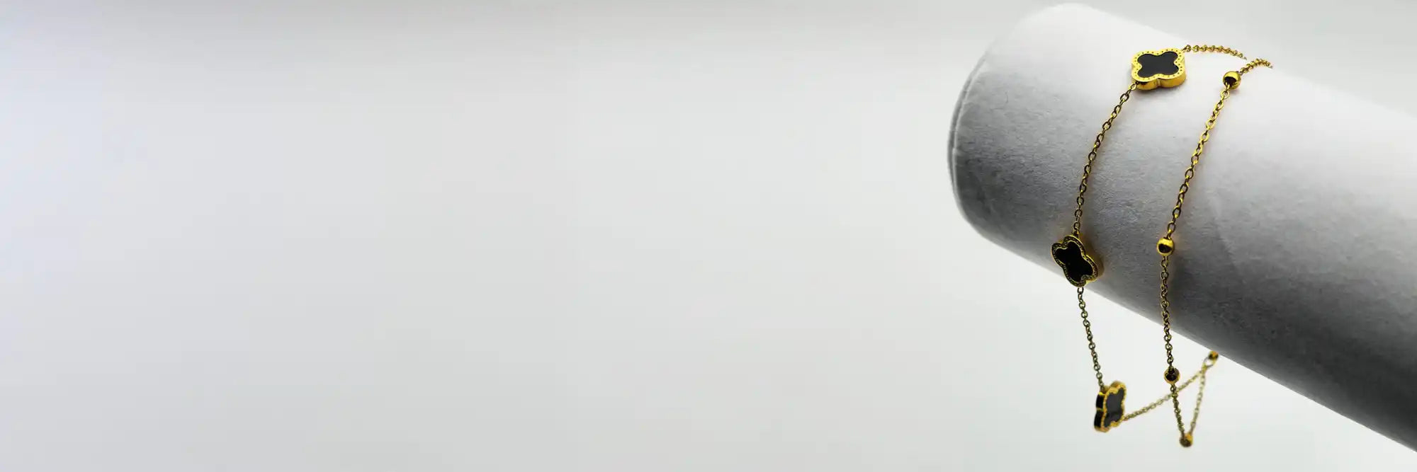 Gold clover charm necklace.