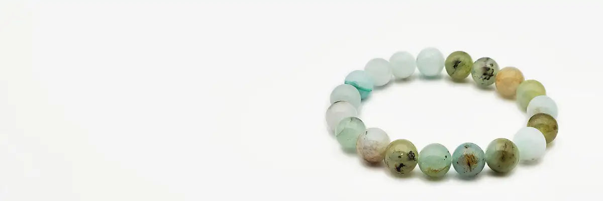 Green and white beaded bracelet with a natural stone design.
