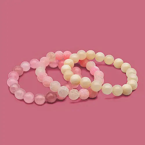 Pastel beaded stretch bracelets with a smooth, matte finish and natural stone beads in shades of pink, white, and cream.